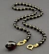 Dark Cherry Amber Pendant Necklace Adorned with Gold Plated Silver