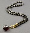Dark Cherry Amber Pendant Necklace Adorned with Gold Plated Silver