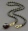 Dark Cherry Amber Pendant Necklace Adorned with Gold Plated Silver